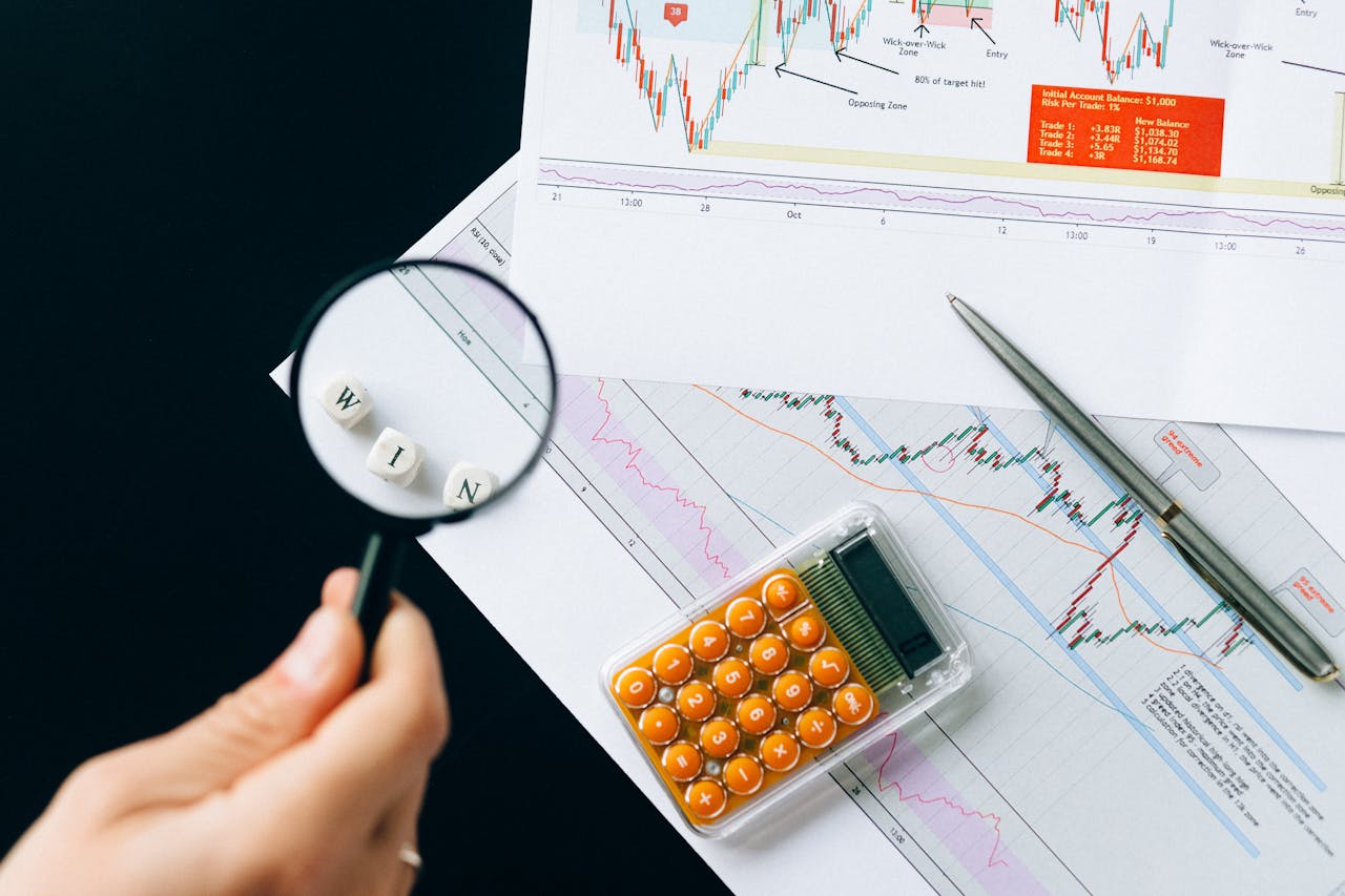 Magnifying glass highlighting the word WIN over financial charts. Enhance your business analysis vision.